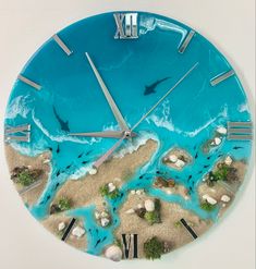 a clock that is made to look like a beach with dolphins swimming in the water