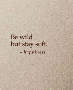 a white wall with a quote on it that says, be wild but stay soft happiness