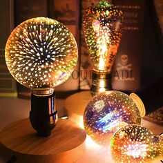 three lights that are sitting on top of a wooden table and one is turned on to look like fireworks