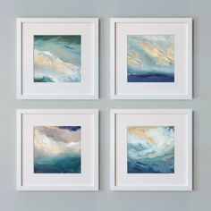 four paintings hanging on the wall above each other in white frames with blue and gold paint