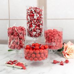 there are many different types of candies in the glass vases on the table