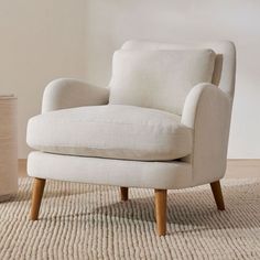 a white chair sitting on top of a rug