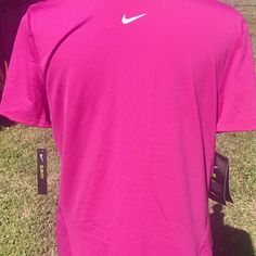 the back of a pink nike shirt on display