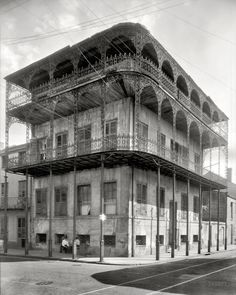 an old french quarter house by streetlight with scaffolding on the upper floor