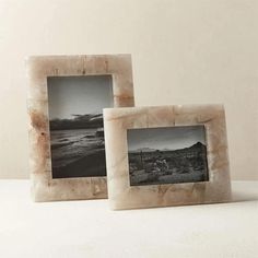 two marble photo frames sitting next to each other