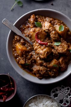 a white bowl filled with meat and rice