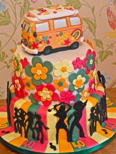 a colorful cake with flowers and people on it