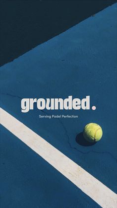 a tennis ball sitting on top of a blue court with the words grounded above it