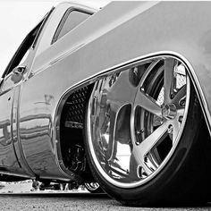 the front end of a classic car with chrome rims