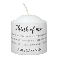 a white candle with the words, think of me on it