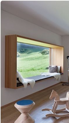 a child's room with wooden furniture and large windows that look out onto the countryside