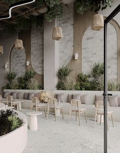 an outdoor seating area with chairs and potted plants on the wall, along with hanging planters