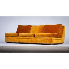 a yellow couch sitting on top of a white floor