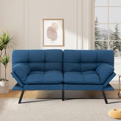 a blue couch sitting on top of a white rug