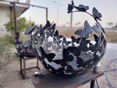 two metal sculptures sitting on top of a wooden table