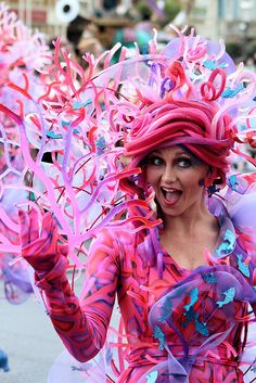 a woman dressed in pink and purple is dancing