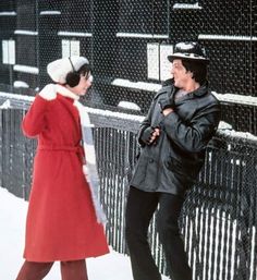 a man and woman standing next to each other in the snow