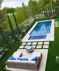 an outdoor living area with a pool and patio furniture