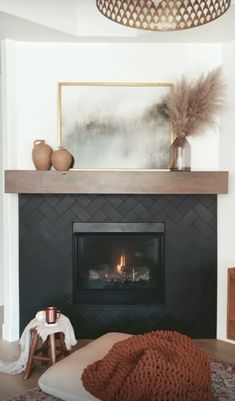 a living room with a fire place in the center and a rug on the floor