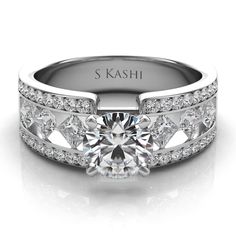 a white gold engagement ring with diamonds on the sides and an engraved name on the side