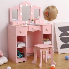 a child's pink vanity with mirror and stool