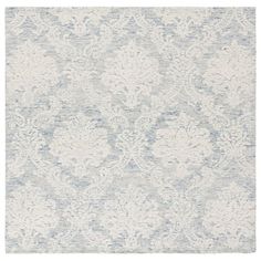 a white and blue rug with an intricate design