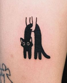 a black cat tattoo on the right thigh