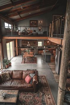 a living room filled with furniture next to a kitchen and an open concept floor plan