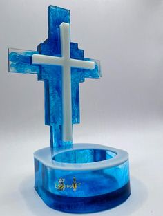 a blue glass crucifix with a white cross on it