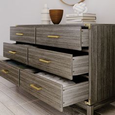 an image of a dresser with drawers in the middle and books on it's top shelf