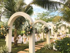 an outdoor wedding setup with flowers and greenery