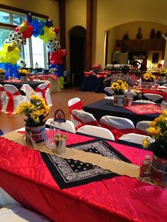 tables set up for an event with red, white and blue linens on them