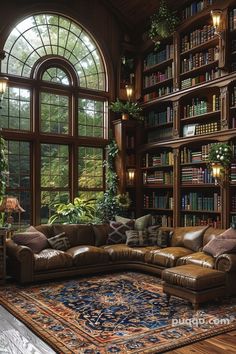 a living room filled with lots of furniture and bookshelves next to a large window