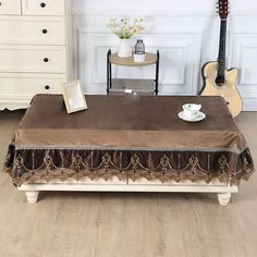 a coffee table with a guitar in the background