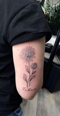 a person with a flower tattoo on their arm