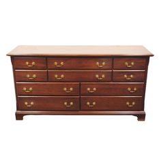 an old wooden dresser with brass handles on the top and bottom, against a white background