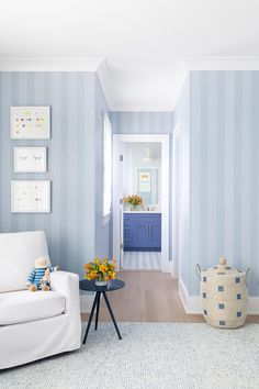 a living room with blue and white striped walls