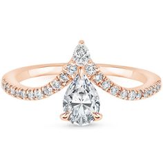 a rose gold engagement ring with a pear shaped diamond in the center and side stones