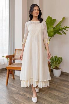 Buy off-white #chanderi #dress with smock pattern on yoke & yellow applique embroidered #floral motifs on sleeve at #AzaFashions Shop online now at #Azafashions.com Call +91 8291990059 or email contactus@azafashions.com for enquiries. #wedding #festive #ethnic #tradional #shopping #shoponline #party डिजाइनर कपड़े, Simple Kurta Designs, Simple Kurti Designs, Frock For Women, Long Kurti Designs, Long Dress Design, Dress Design Patterns