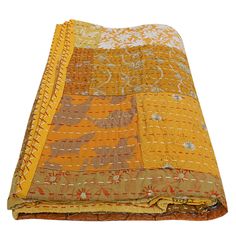 an orange and yellow blanket is laying on top of a white surface with the fabric folded over it