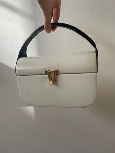 Classically beautiful 1960s bag from Rosenfeld for Saks Fifth Avenue. Light ivory leather with navy sides and handle - great sculptural design. Gold tone clasp. Four protector feet on bottom. Interior is navy grosgrain moire; tag says Rosenfeld Saks Fifth Avenue. From a private collection and stored for many years, this is in very good vintage condition and super usable.  Approx. 8-1/2 wide x 5-1/2 tall (to top of bag) x 4-1/2 front to back. Roomy enough for all your essentials In great vintage Basic Instinct, Mid Modern, Leather Paint, Light Ivory, Top Handle Bags, Handbag Heaven, Vintage Purses, Style And Grace, Vintage Handbags