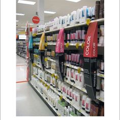 an aisle in a store filled with lots of bottles and shampoos on the shelves