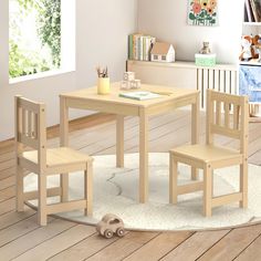 a child's table and chairs in a room with hardwood floors, white rugs and bookshelves