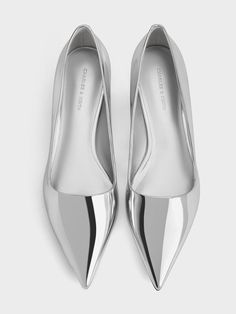 Take things up a notch with a shiny, metallic finish. The classic pointed toes of these pumps look especially sleek in silver, while the square vamps enhance their clean-lined appeal. They are not only easy to slip into, but will also add a touch of polish to any outfit. Whether you wear them to the office or on the dancefloor, these pumps will definitely make a statement. Silver Shoes Outfit, Metallic Shoes Outfit, Pointy Shoes, 2025 Style, Silver Pumps, Metallic Shoes, Kitten Heel Pumps, Shoes Outfit, Charles Keith