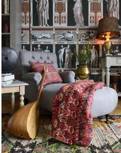 a living room filled with furniture and pictures on the wall