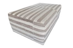 a white and gray striped ottoman sitting on top of a floor