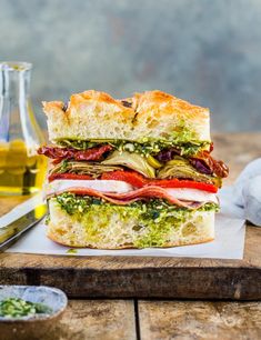 a cut in half sandwich sitting on top of a cutting board