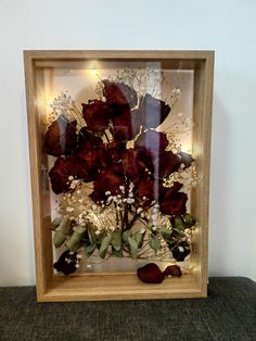 a wooden frame with flowers in it