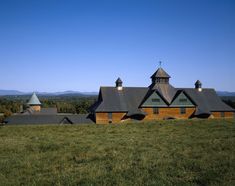 a large building with two towers on top of it in the middle of a field