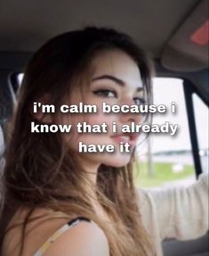 a woman sitting in a car with the words i'm calm because i know that i already have it